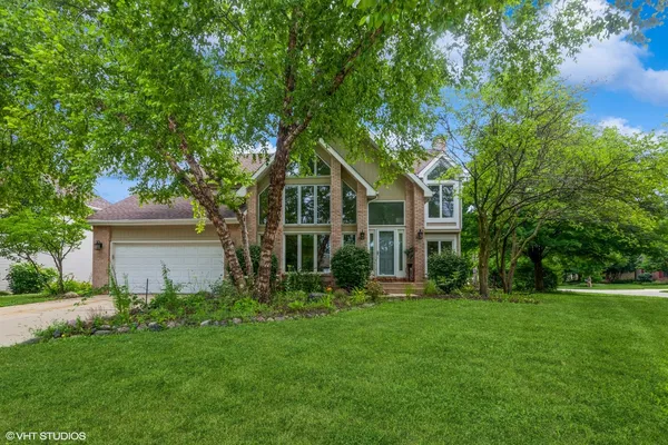 a front view of house with yard and green space