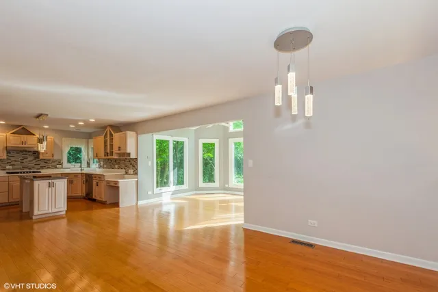 a view of a kitchen with a stove cabinets and a floor to ceiling window