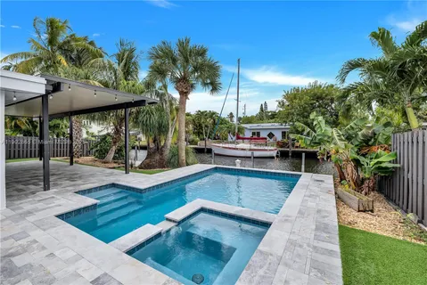 a view of a patio with swimming pool table and chairs