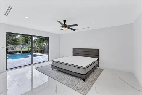 a room with pool table and glass door