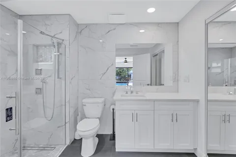 a bathroom with a toilet a sink and shower