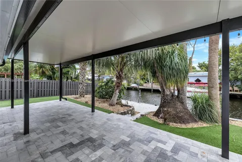 a view of a porch with chairs and backyard