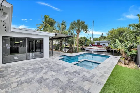a view of a backyard with plants and outdoor seating