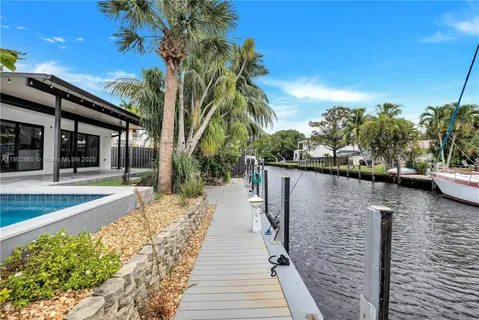 a view of a lake with boats and palm trees