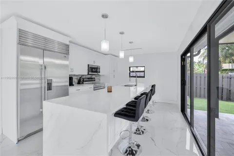 a kitchen with stainless steel appliances a refrigerator and a stove top oven