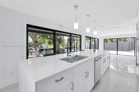 a kitchen with a sink and large window