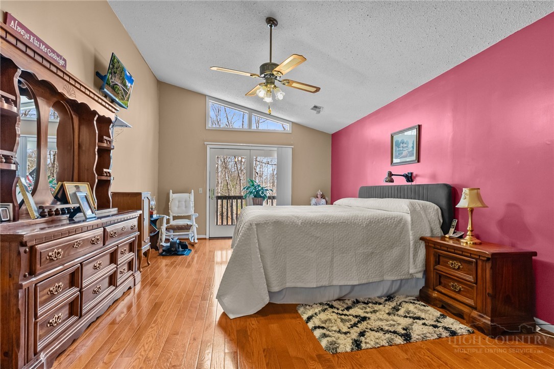 271 Quail Hollow Road Crumpler, NC 28617 - Photo 20 of 30 a bedroom with a bed and wooden floor