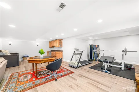 a living room with furniture a air conditioner and a table
