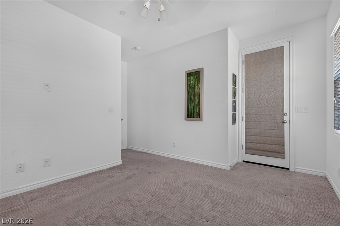 1824 Redland Ridge Street Henderson, NV 89002 - Photo 27 of 69 A well-lit room offering plush carpeting and a glass-paneled door for abundant natural light.