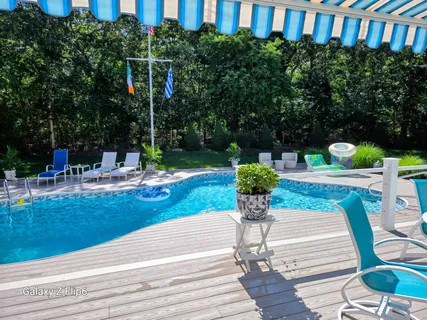 a view of a patio with couches table and chairs and potted plants