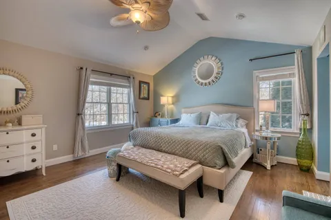 a spacious bedroom with a bed and a chandelier