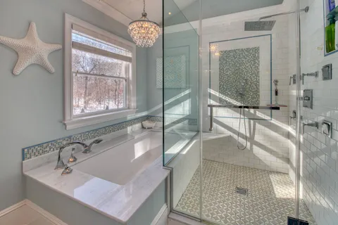 a bathroom with a tub sink and mirror