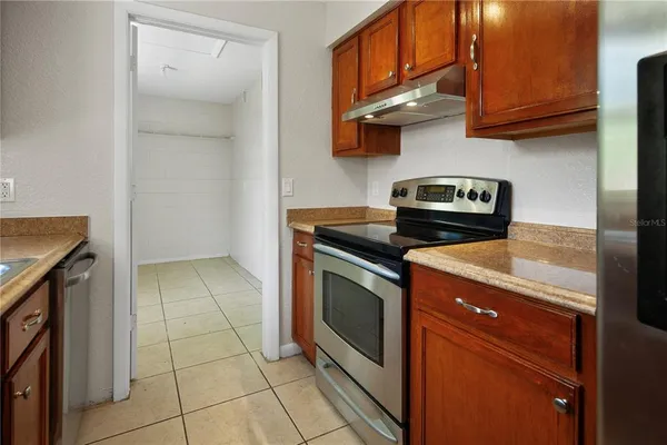 a kitchen with a stove cabinets and a sink