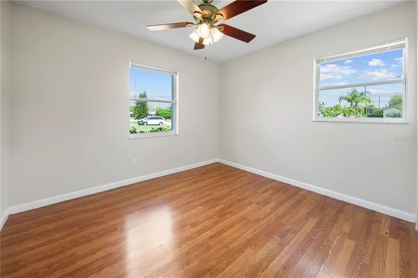 wooden floor in an empty room with a window
