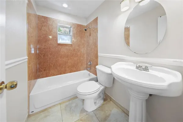 a bathroom with a sink toilet and a mirror