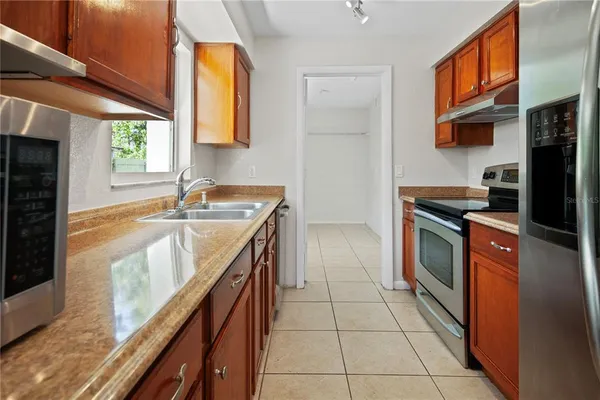 a kitchen with stainless steel appliances granite countertop a sink and a stove