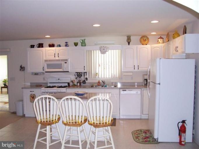 25813 Hunters Point Lane Denton, MD 21629 - Photo 4 of 5 a kitchen with a sink dishwasher a refrigerator and a stove