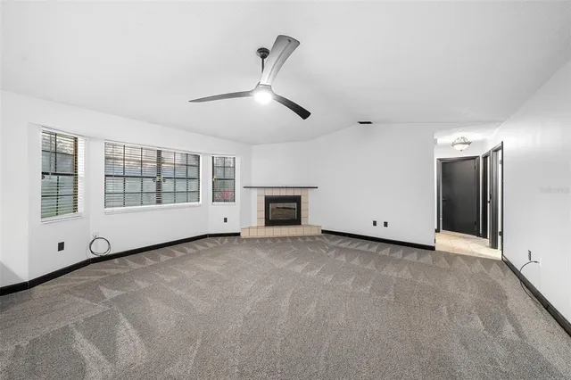a view of a livingroom with an empty space and a fireplace