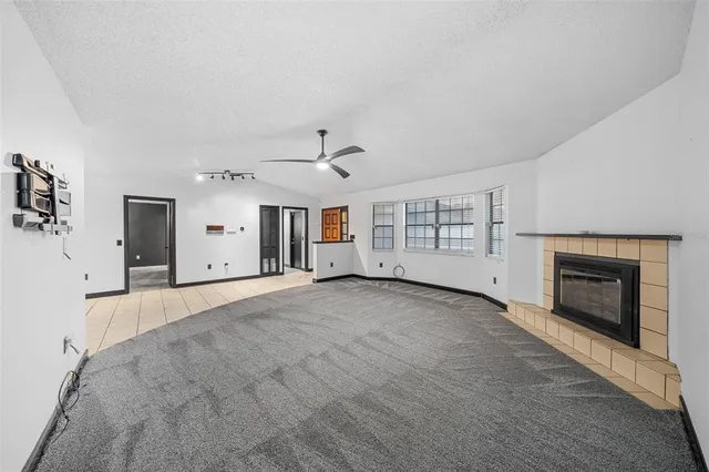 a view of a porch with furniture and floor to ceiling window