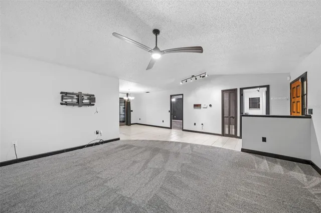 a view of an empty room with a ceiling fan
