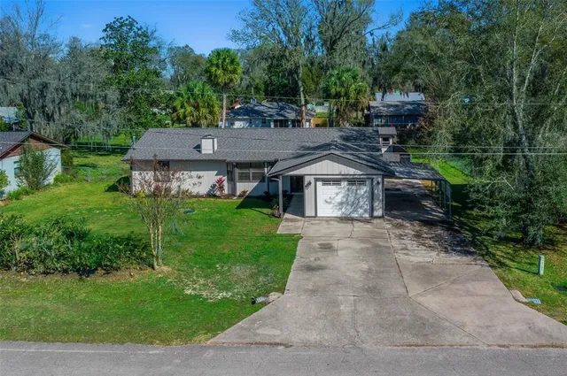 an aerial view of house with a yard