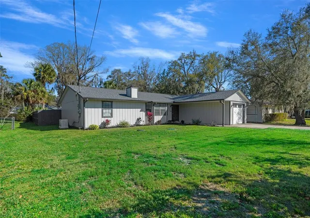a view of a house with a back yard