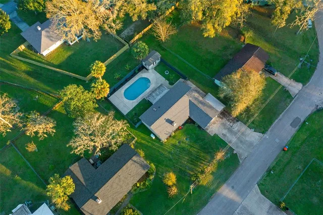 an aerial view of house with yard swimming pool and outdoor seating