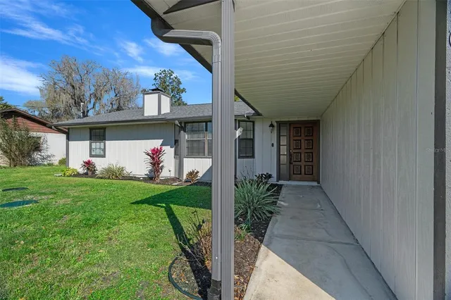 a view of a porch with a table and chairs