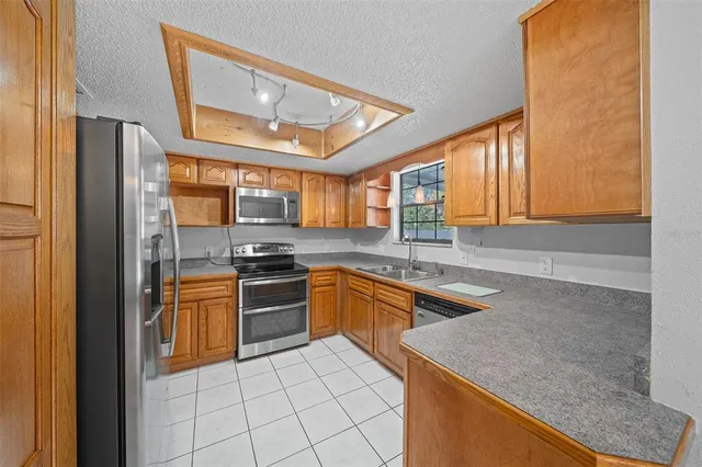 a kitchen with a sink cabinets and window