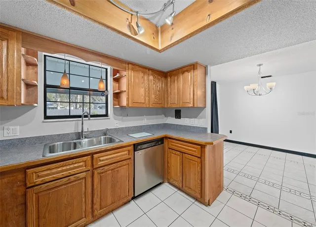 a kitchen that has a sink and a stove