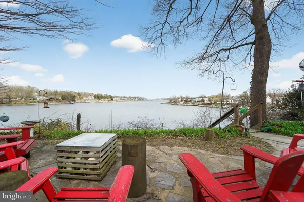 a view of a lake with couches chairs and city view