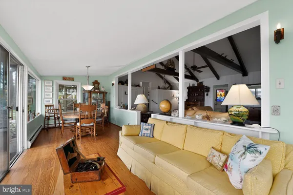 a kitchen with stainless steel appliances white cabinets and wooden floors