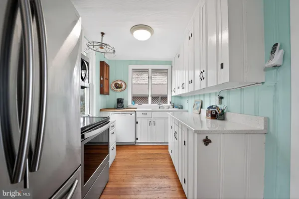 a kitchen with stainless steel appliances a refrigerator sink and microwave