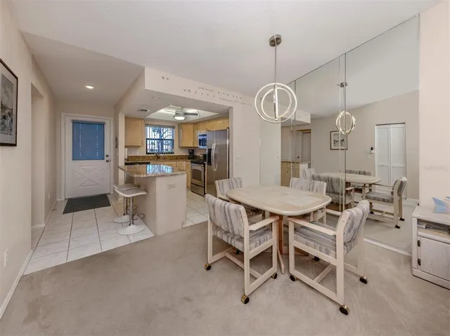 a kitchen with stainless steel appliances granite countertop a sink a stove a refrigerator and cabinets