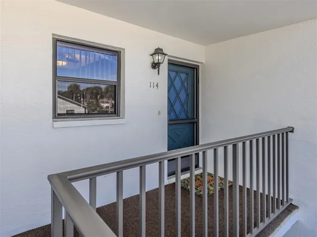 a view of a balcony with chair and table