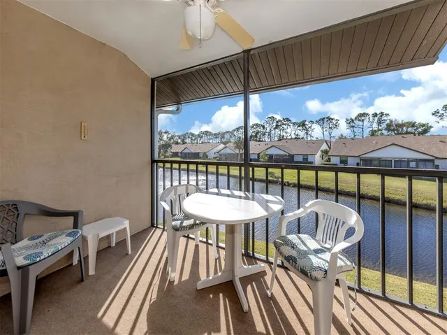a view of a balcony with chair and wooden floor