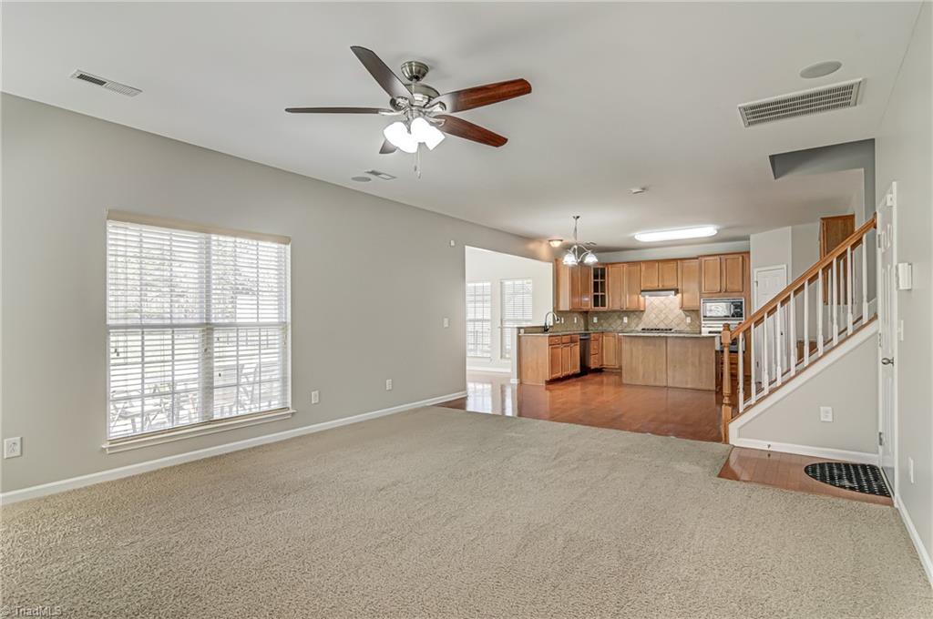 5421 Broadleaf Road Summerfield, NC 27358 - Photo 14 of 30 The stairs with the pickets take you upstairs to the four bedrooms and loft