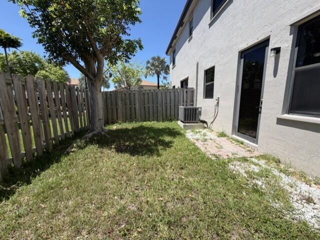 23765 Southwest 118 Avenue, Unit 23765 Homestead, FL 33032 - Photo 23 of 36 a view of backyard with wooden fence and large trees