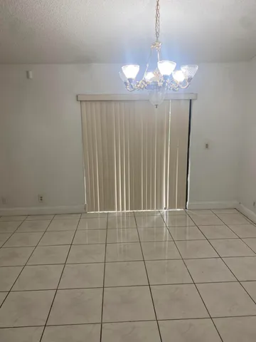 a view of a livingroom with a chandelier fan