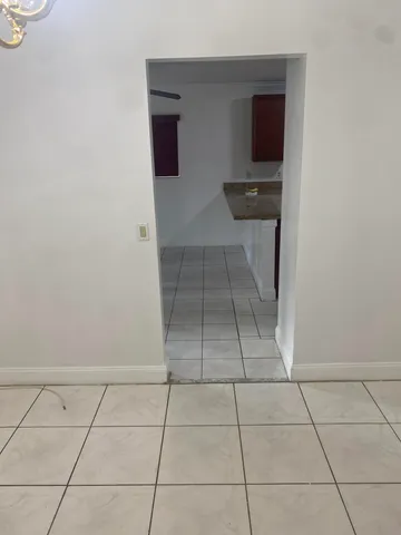 a view of a kitchen with white cabinets