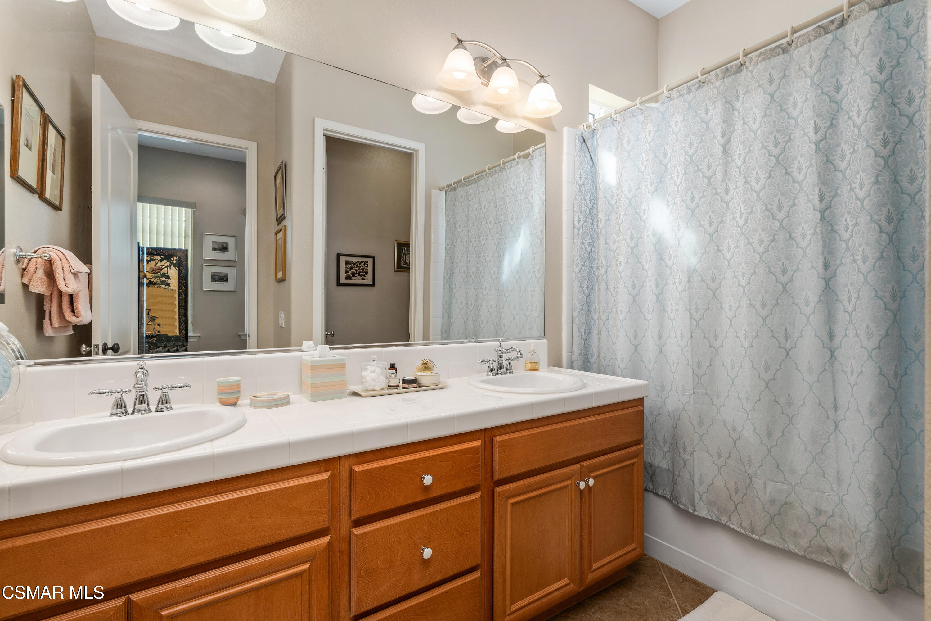 6835 Blue Ridge Way Moorpark, CA 93021 - Photo 15 of 39 a bathroom with a double vanity sink and a mirror