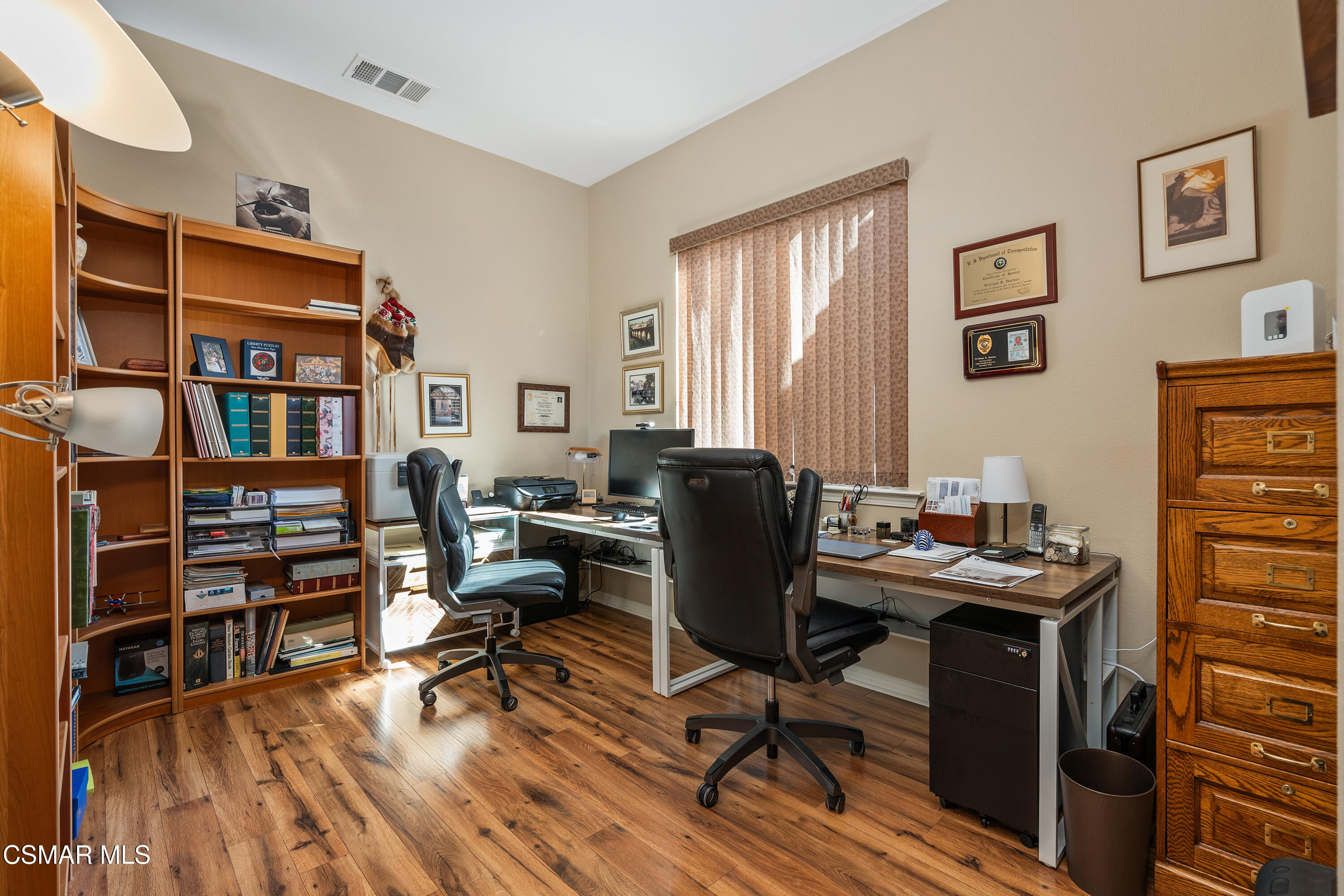 6835 Blue Ridge Way Moorpark, CA 93021 - Photo 16 of 39 a view of a workspace with furniture and a bookshelf