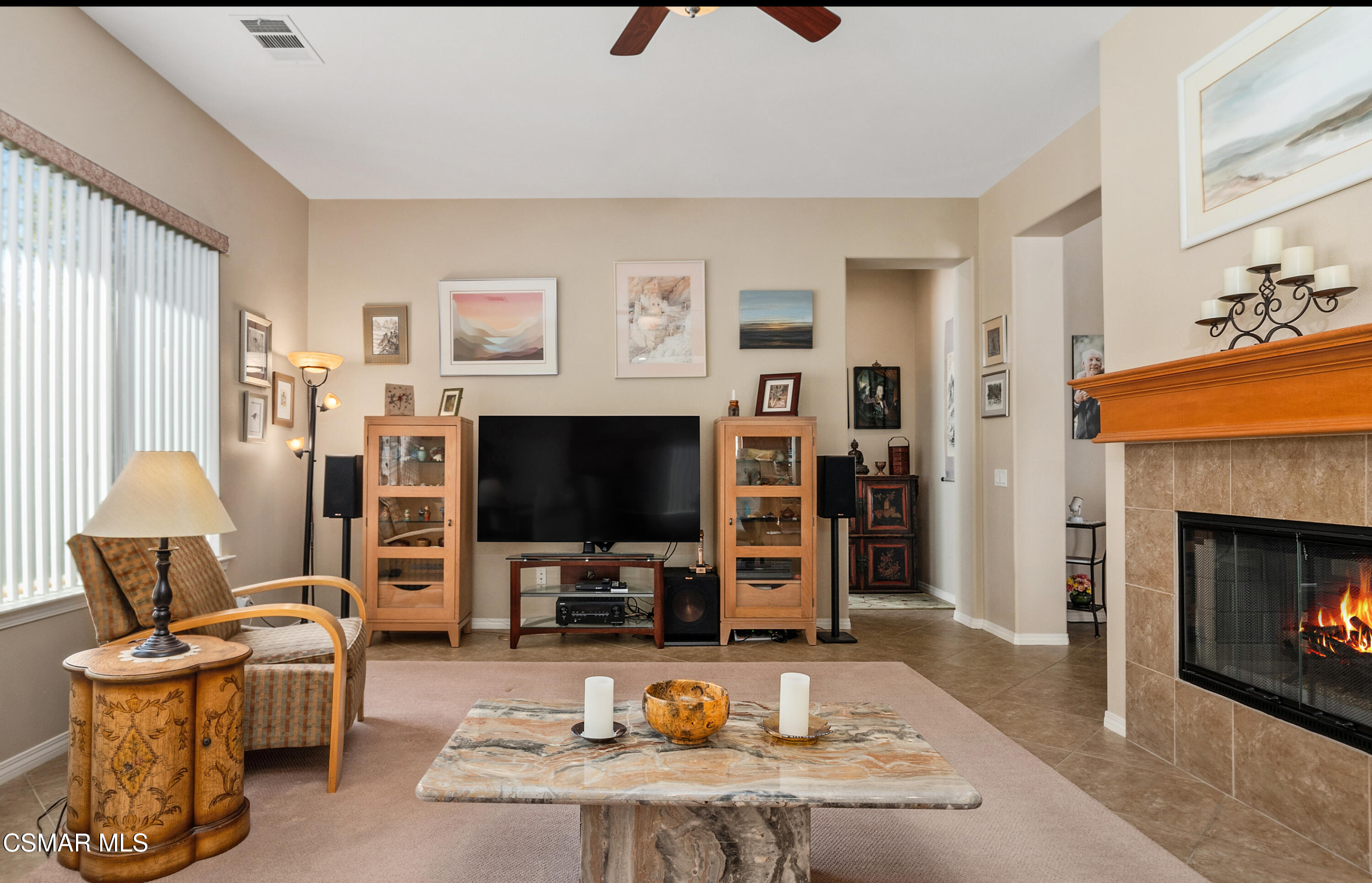 6835 Blue Ridge Way Moorpark, CA 93021 - Photo 4 of 39 a living room with furniture a fireplace and a flat screen tv