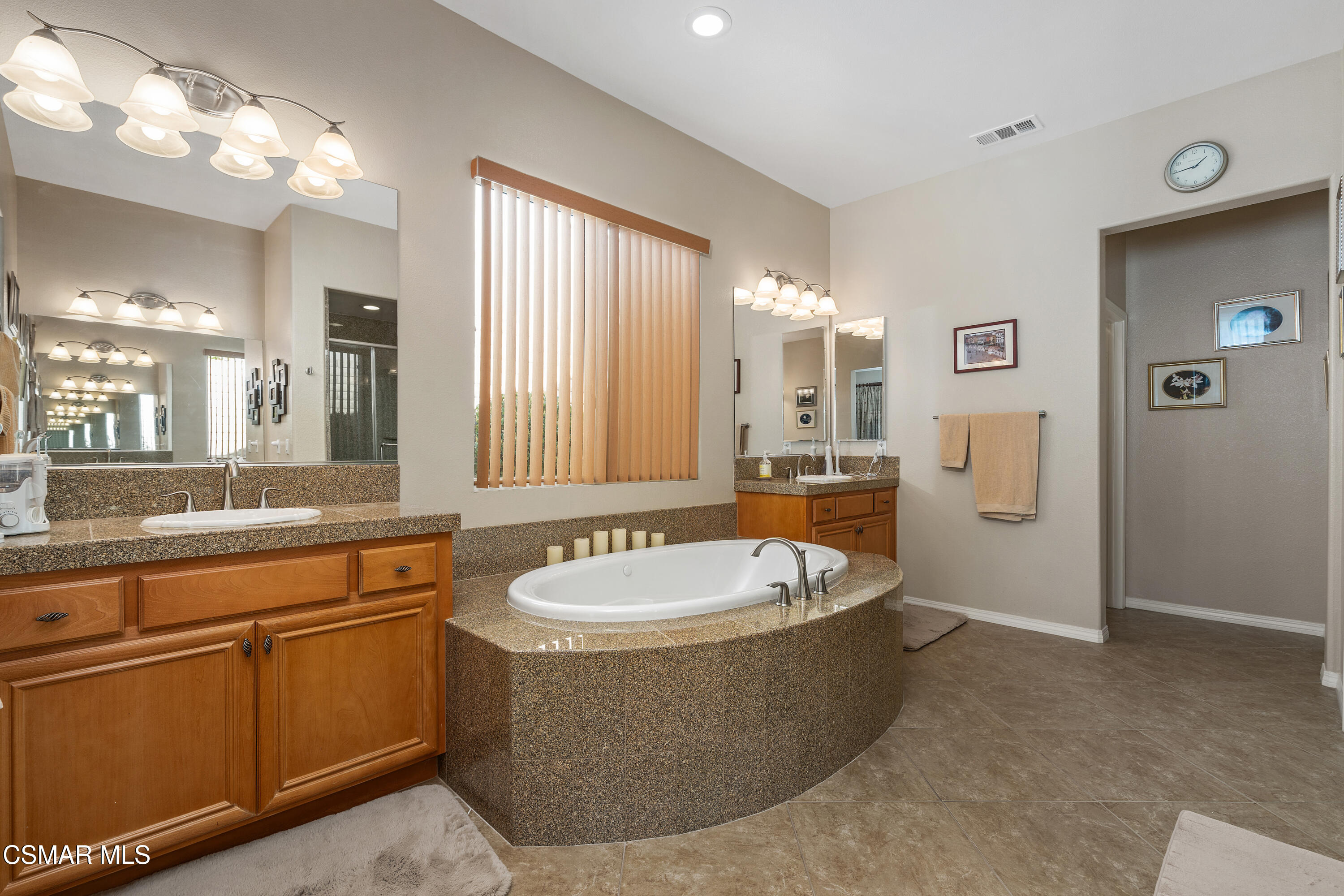6835 Blue Ridge Way Moorpark, CA 93021 - Photo 9 of 39 a spacious bathroom with a tub sink and mirror