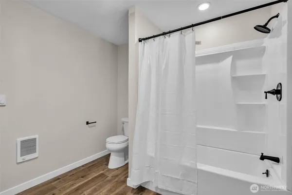 a bathroom with a shower curtain and a toilet