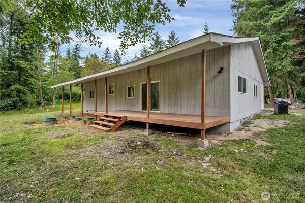 a view of a house with a yard and sitting area