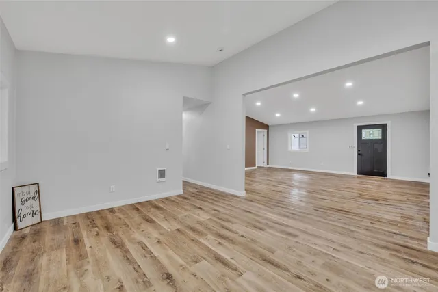 a view of empty room with wooden floor
