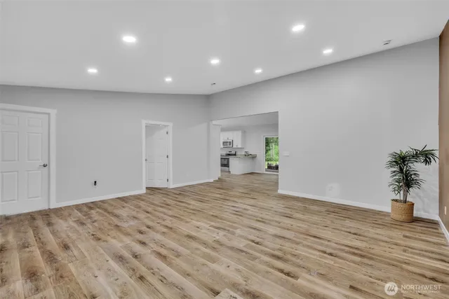 a view of empty room with wooden floor
