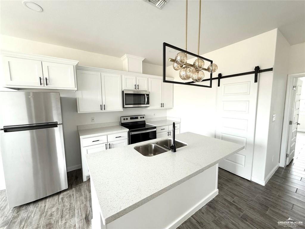 5401 North Crown Point Pharr, TX 78577 - Photo 2 of 11 a kitchen with appliances a counter space and cabinets