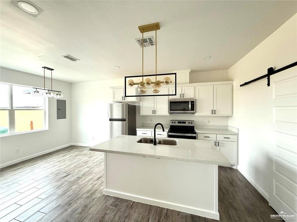 5401 North Crown Point Pharr, TX 78577 - Photo 3 of 11 a kitchen with stainless steel appliances a sink stove and refrigerator